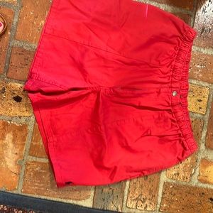 Men’s red polo shorts with elastic waist. Size XL